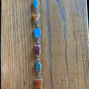 Native American made multi stones and sterling bracelet.